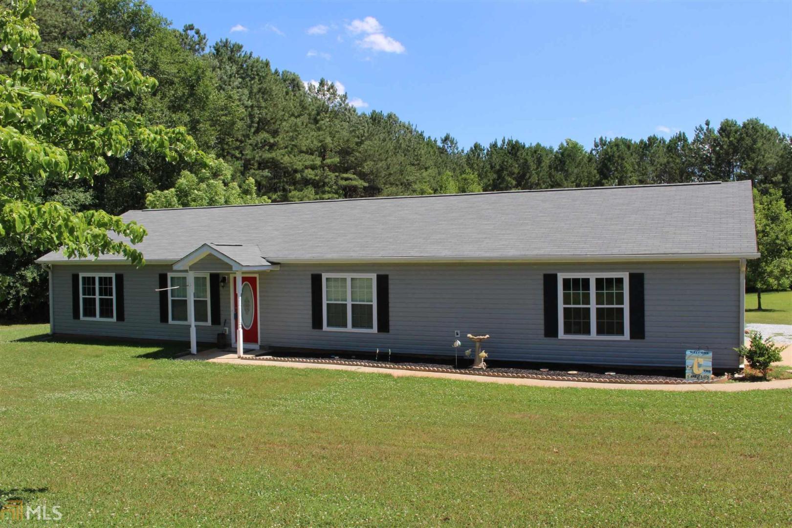 1297 Macedonia Road Newnan, GA 30263 - Photo 1 of 1 front view of a house with a yard