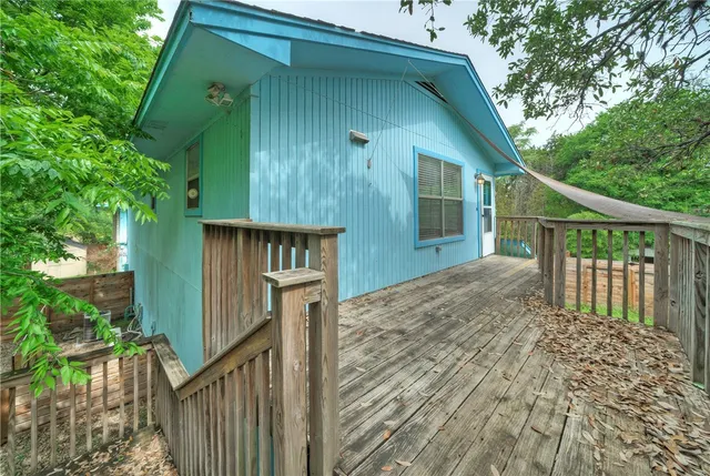 a view of a house with wooden fence