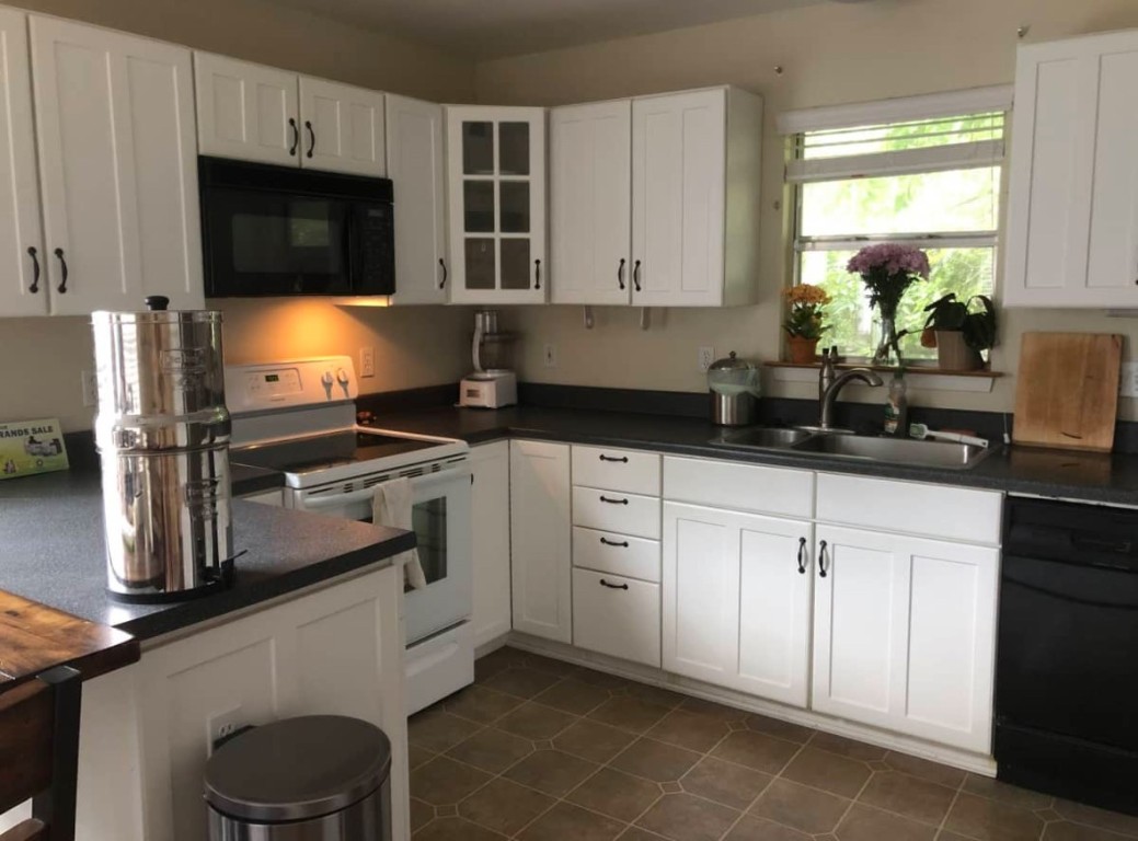 2105 Rabb Road, Unit UPPR Austin, TX 78704 - Photo 4 of 15 a kitchen with stainless steel appliances a stove a sink a microwave a refrigerator and cabinets