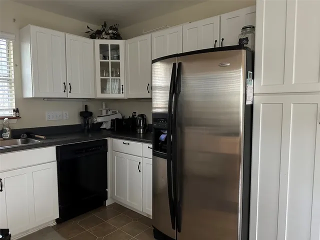 a kitchen with a refrigerator and cabinets