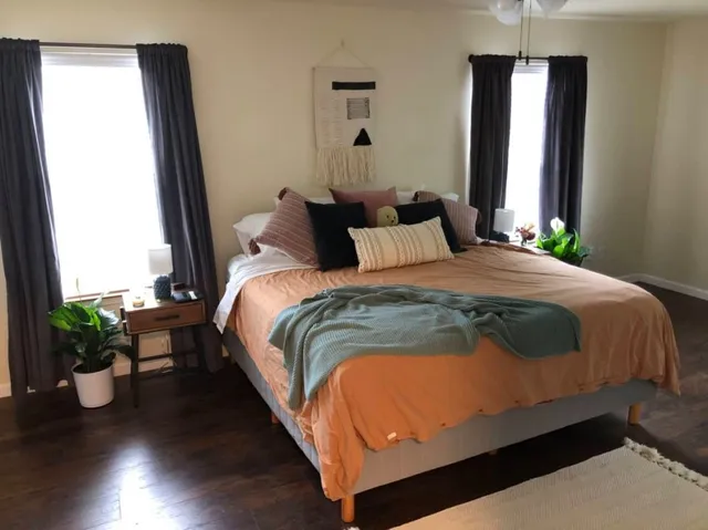 a bedroom with bed and window