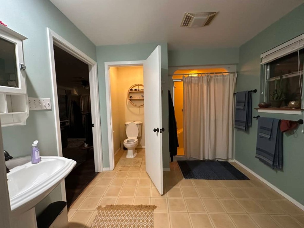 2105 Rabb Road, Unit UPPR Austin, TX 78704 - Photo 7 of 15 a bathroom with a sink a toilet and shower
