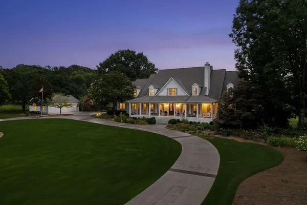 a front view of a house with a garden