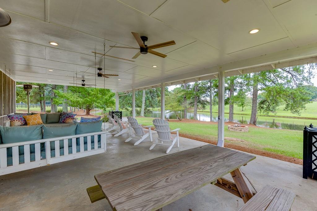 986 Austin Road Winder, GA 30680 - Photo 106 of 135 a view of a patio with a table chairs and a backyard