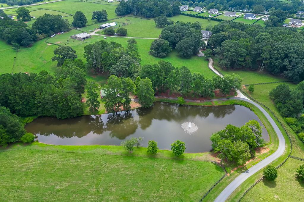 986 Austin Road Winder, GA 30680 - Photo 115 of 135 an aerial view of green landscape with trees houses and lake view