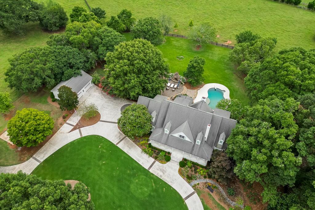 986 Austin Road Winder, GA 30680 - Photo 116 of 135 an aerial view of a house with a garden and swimming pool
