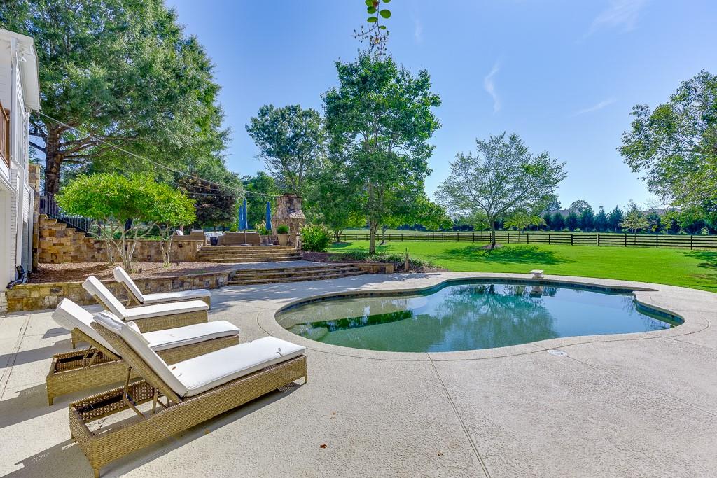 986 Austin Road Winder, GA 30680 - Photo 120 of 135 a view of a swimming pool with a yard and a sitting area