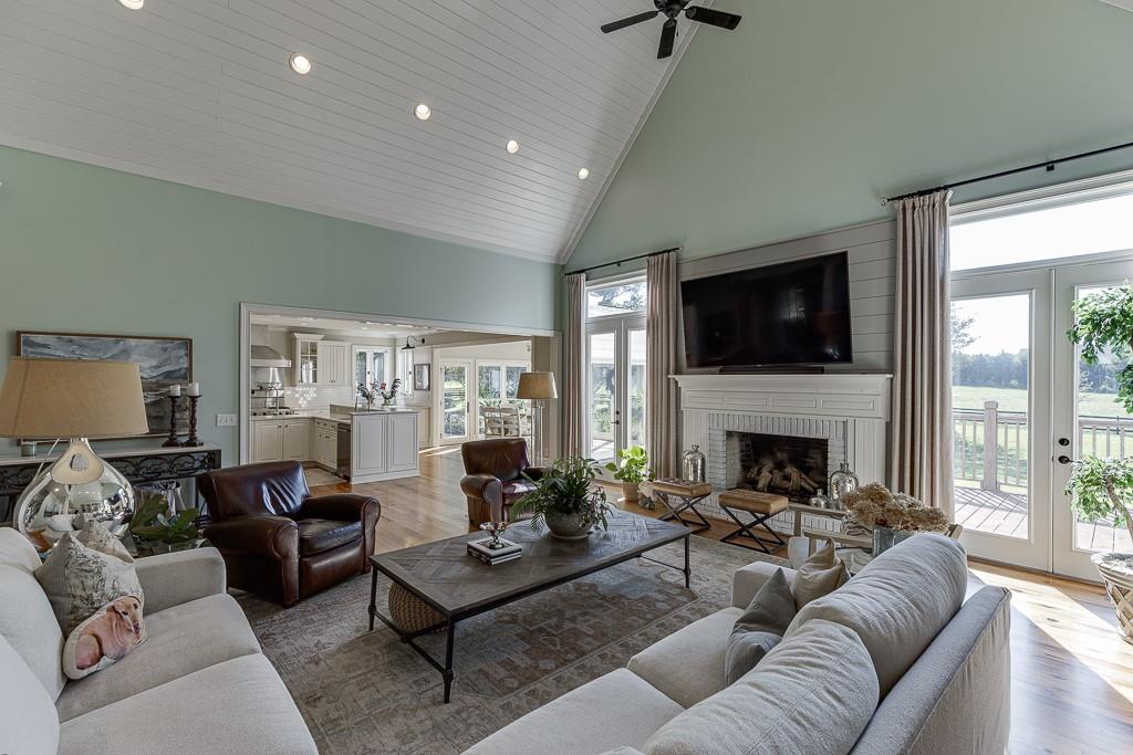 986 Austin Road Winder, GA 30680 - Photo 19 of 135 a living room with furniture a fireplace and a flat screen tv