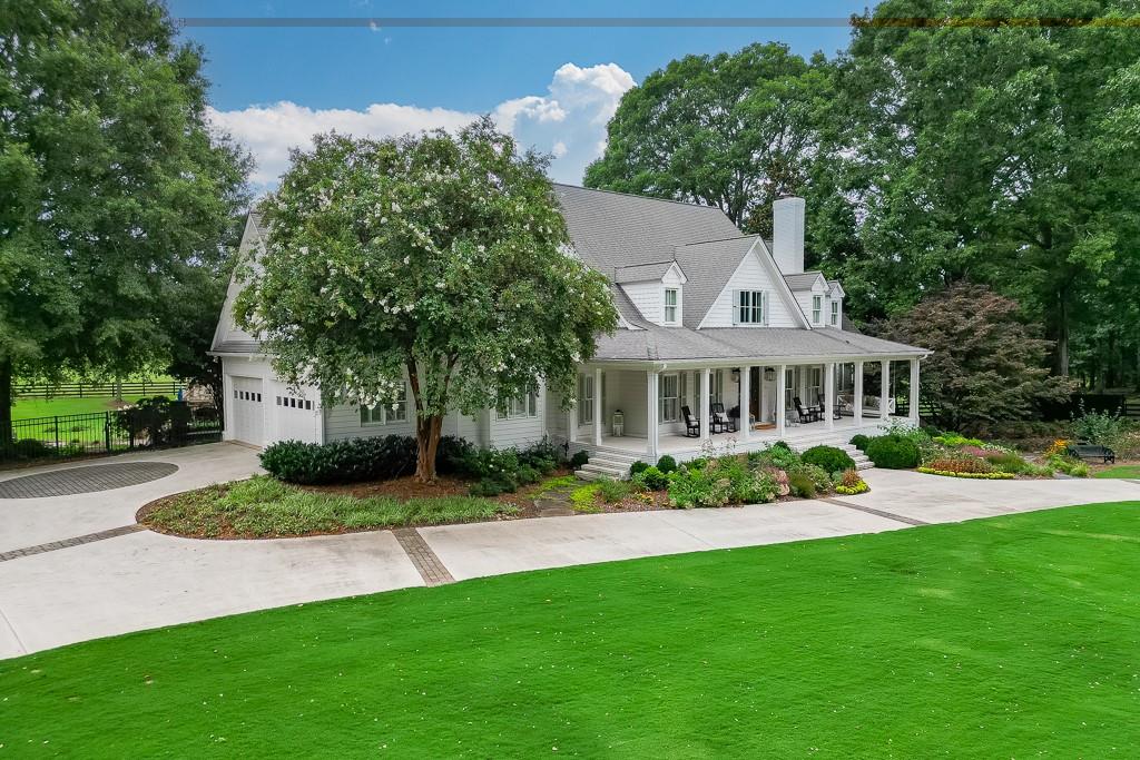 986 Austin Road Winder, GA 30680 - Photo 3 of 135 a front view of a house with a garden