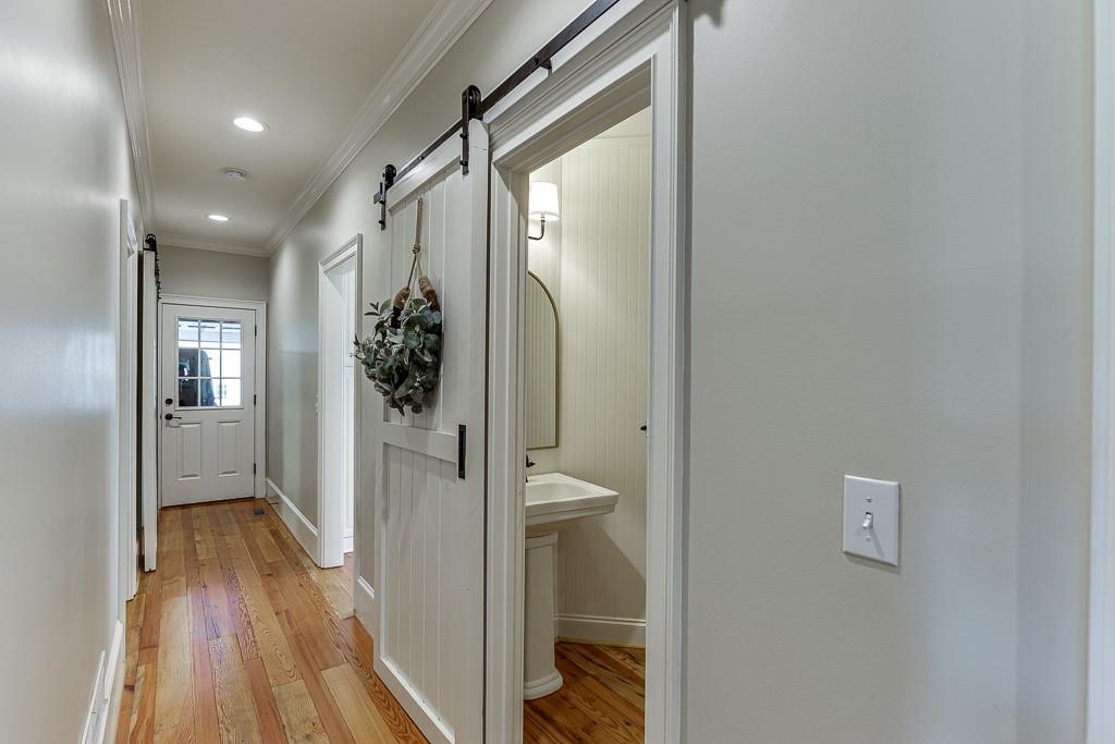 986 Austin Road Winder, GA 30680 - Photo 39 of 135 a view of a hallway with wooden floor and a bathroom