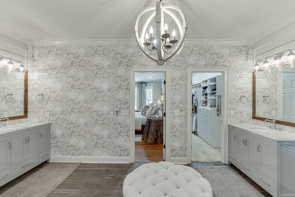 986 Austin Road Winder, GA 30680 - Photo 46 of 135 a spacious bathroom with a granite countertop sink a mirror and shower
