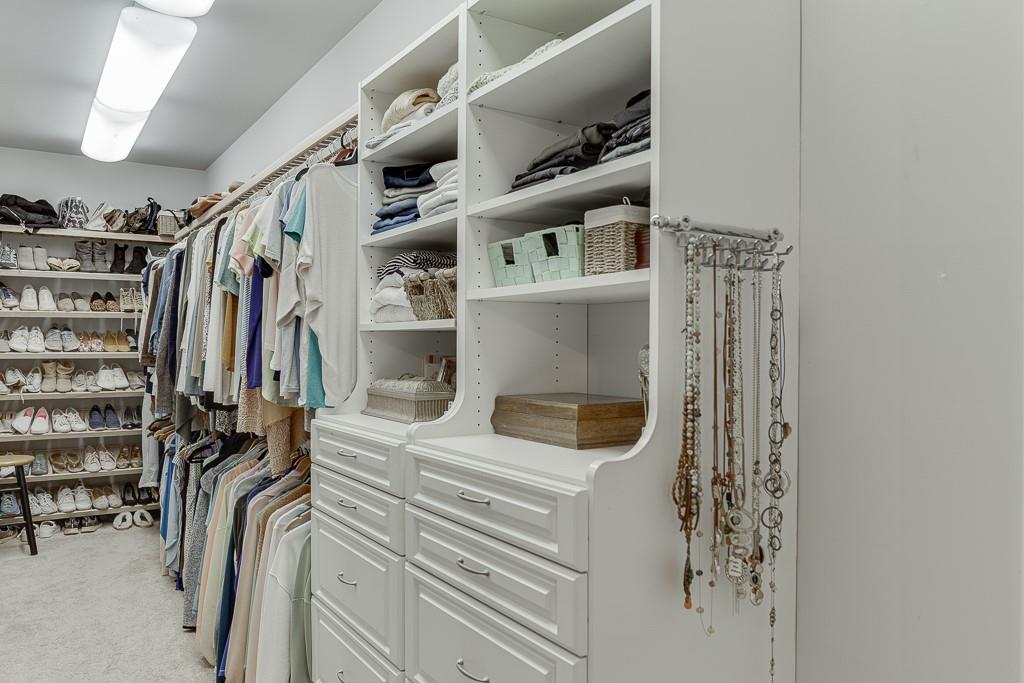 986 Austin Road Winder, GA 30680 - Photo 49 of 135 a view of walk in closet with clothes and shoes