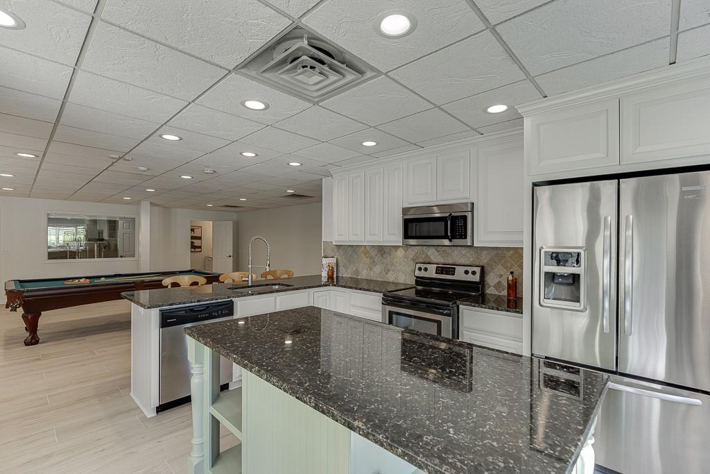 986 Austin Road Winder, GA 30680 - Photo 74 of 135 a kitchen with stainless steel appliances granite countertop a sink a stove and a refrigerator