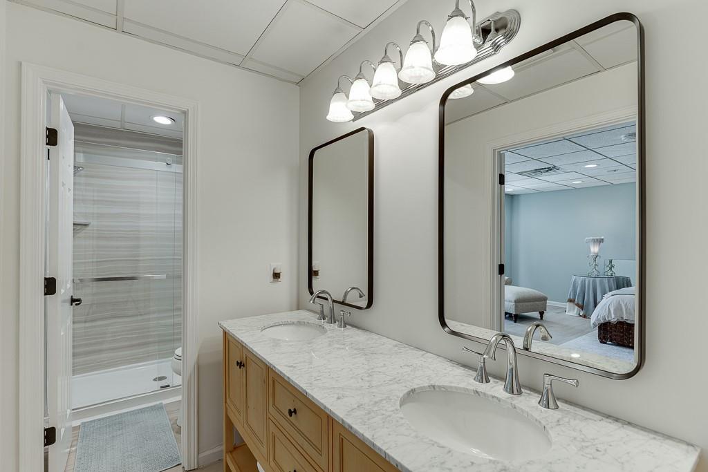 986 Austin Road Winder, GA 30680 - Photo 87 of 135 a bathroom with a granite countertop sink a light fixture and a mirror