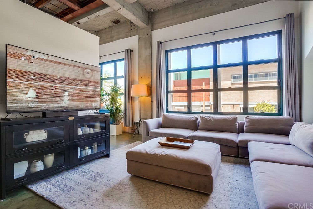 100 West 5th Street Long Beach, CA 90802 - Photo 1 of 53 a living room with furniture and floor to ceiling windows