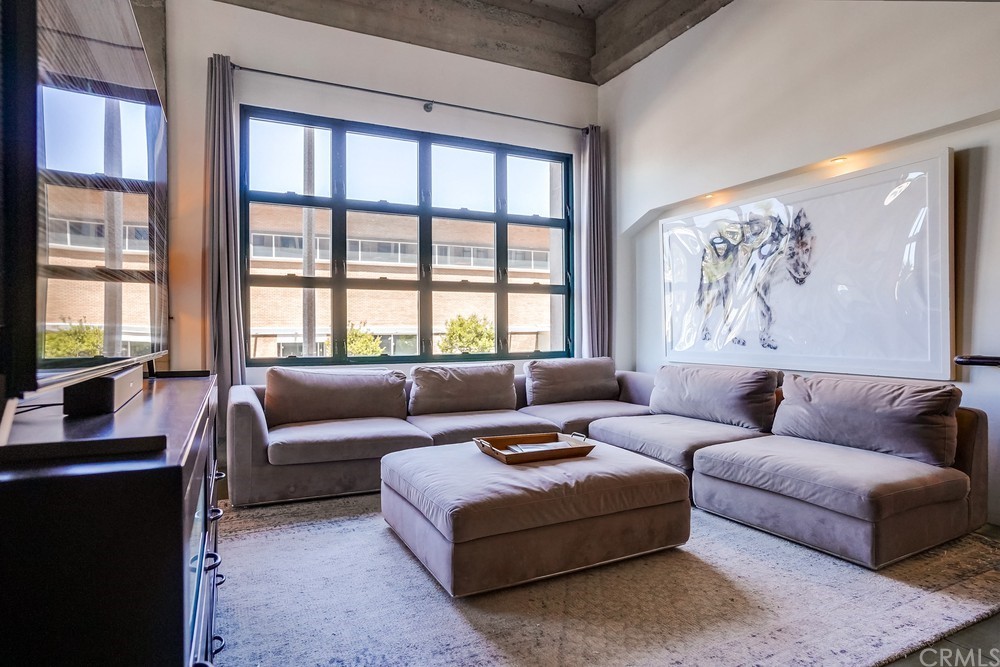 100 West 5th Street Long Beach, CA 90802 - Photo 13 of 53 a living room with furniture and a large window