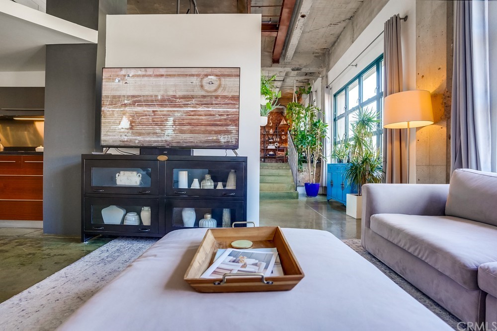 100 West 5th Street Long Beach, CA 90802 - Photo 14 of 53 a living room with furniture and a floor to ceiling window