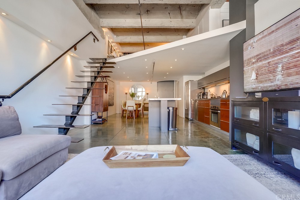 100 West 5th Street Long Beach, CA 90802 - Photo 16 of 53 a living room with lots of furniture wooden floor and a chandelier