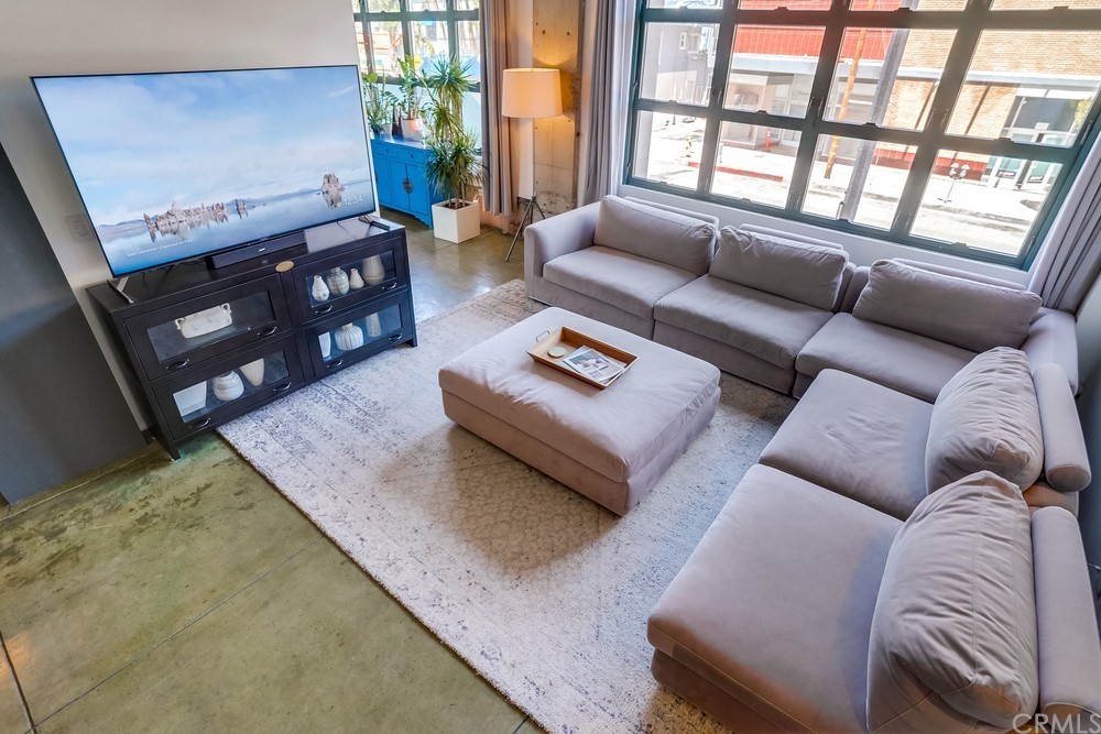 100 West 5th Street Long Beach, CA 90802 - Photo 19 of 53 a living room with furniture and a flat screen tv