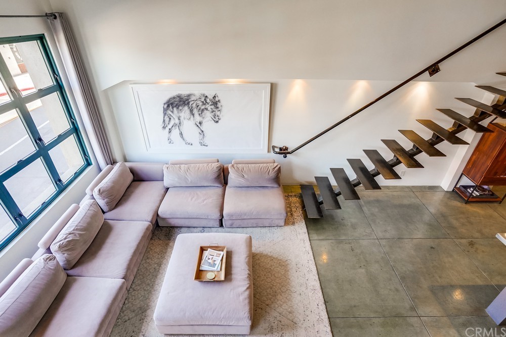 100 West 5th Street Long Beach, CA 90802 - Photo 20 of 53 a view of staircase with lots of frames on wall and a large window