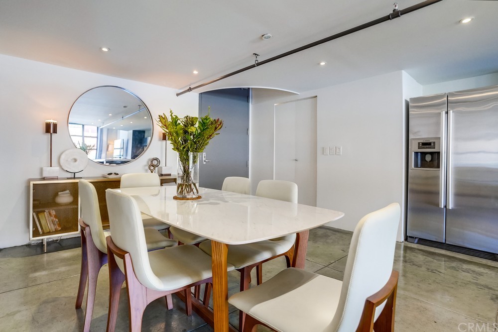 100 West 5th Street Long Beach, CA 90802 - Photo 3 of 53 a view of a dining room with furniture and wooden floor