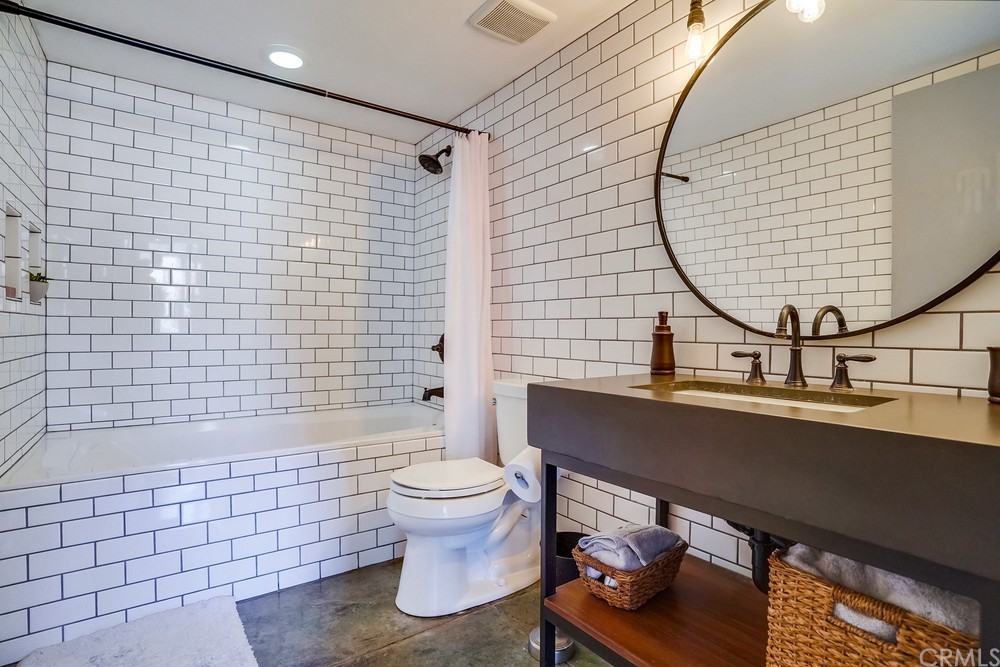 100 West 5th Street Long Beach, CA 90802 - Photo 32 of 53 a bathroom with a sink a toilet and shower