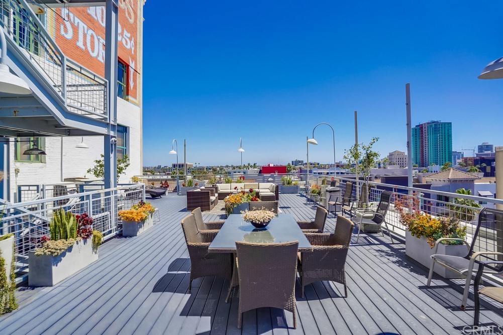 100 West 5th Street Long Beach, CA 90802 - Photo 44 of 53 a view of roof deck with dining table and chairs barbeque with wooden floor