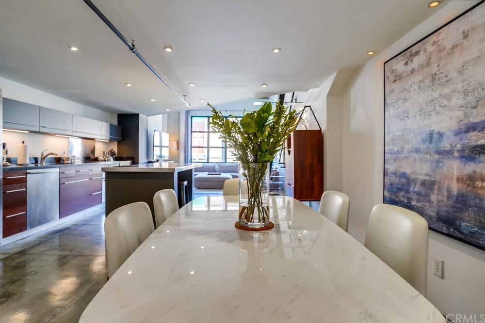 100 West 5th Street Long Beach, CA 90802 - Photo 6 of 53 a living room with furniture a potted plant and kitchen view
