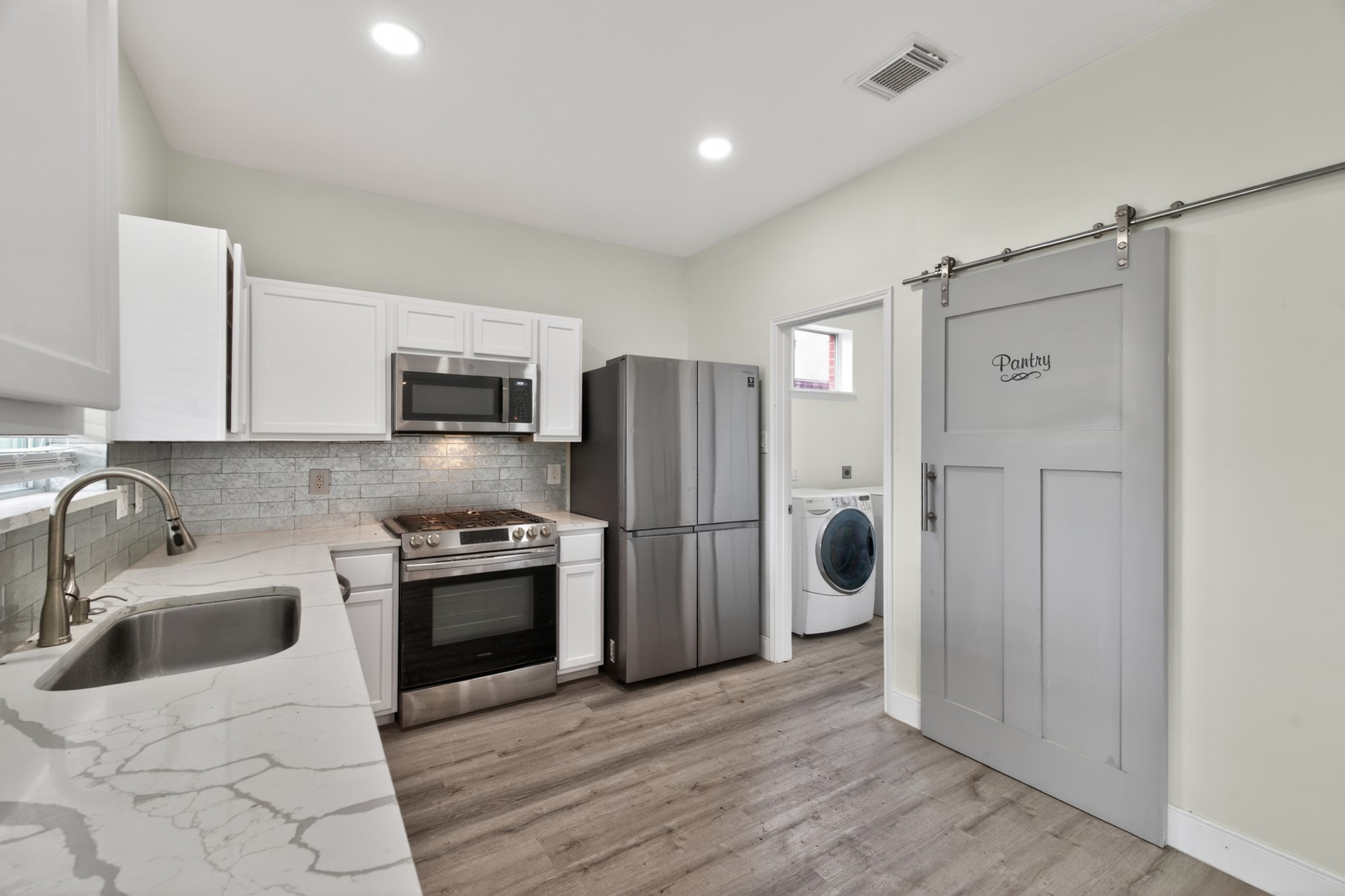 918 Ivycroft Lane Spring, TX 77373 - Photo 13 of 33 a kitchen with stainless steel appliances granite countertop a refrigerator and a sink