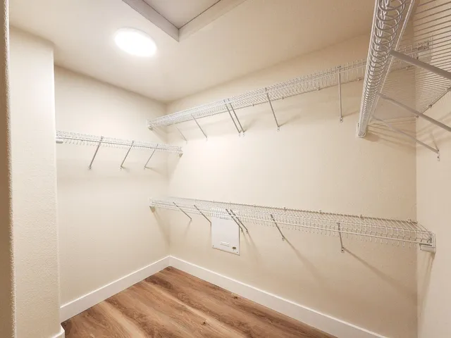 a view of a room with wooden floor and window