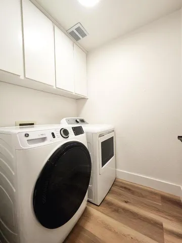 a view of a house with a yard and wooden fence