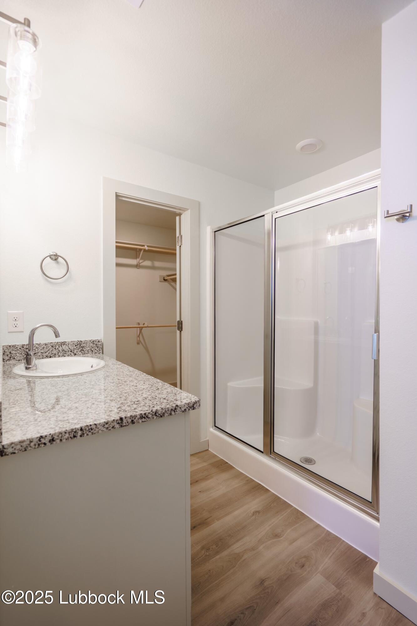 8010 Elm Avenue Lubbock, TX 79404 - Photo 7 of 12 a bathroom with a granite countertop sink and a mirror