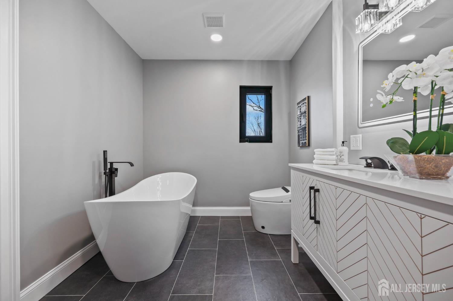 120 Nolan Road Morganville, NJ 07751 - Photo 26 of 85 a bathroom with a toilet sink and mirror