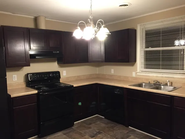 a kitchen with a sink and a window