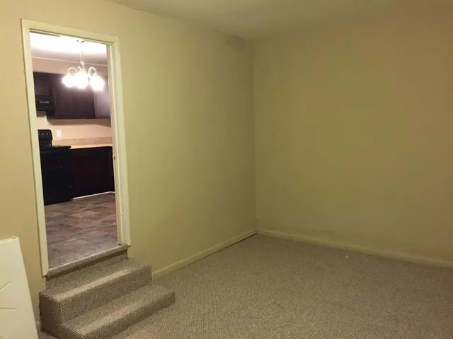 en suite bathroom with a light fixture and a sink
