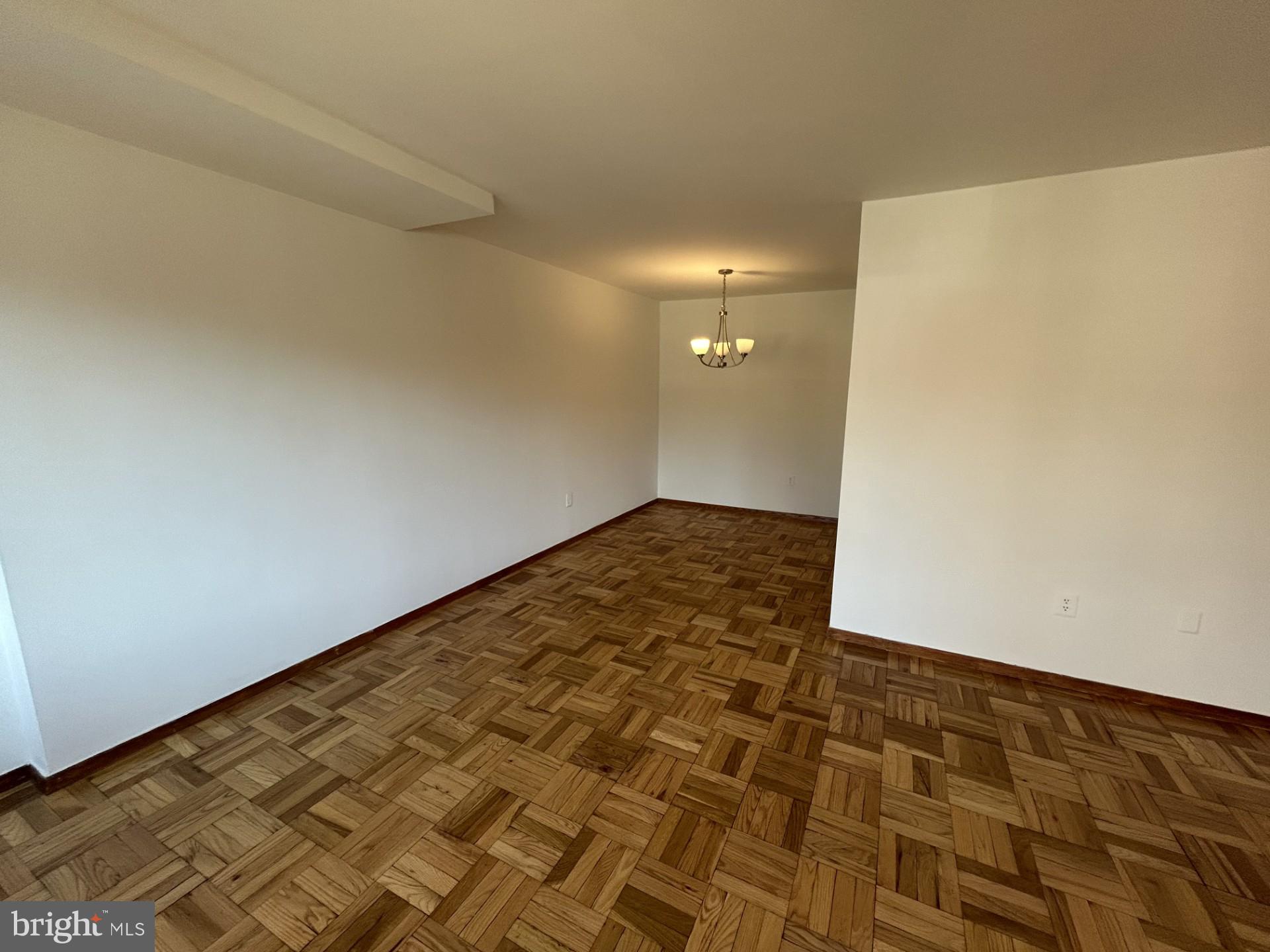 4000 Tunlaw Road Northwest, Unit 223 Washington, DC 20007 - Photo 12 of 28 wooden floor in an empty room