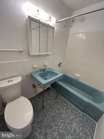 a bathroom with a toilet sink and shower