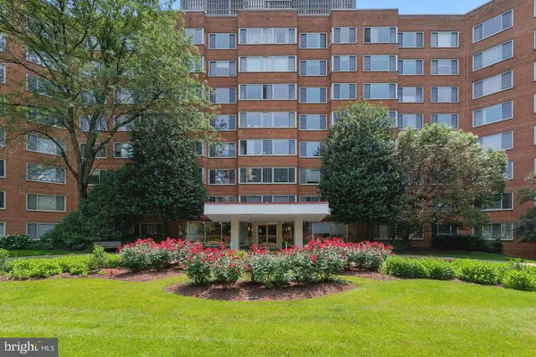 a front view of building with yard and green space