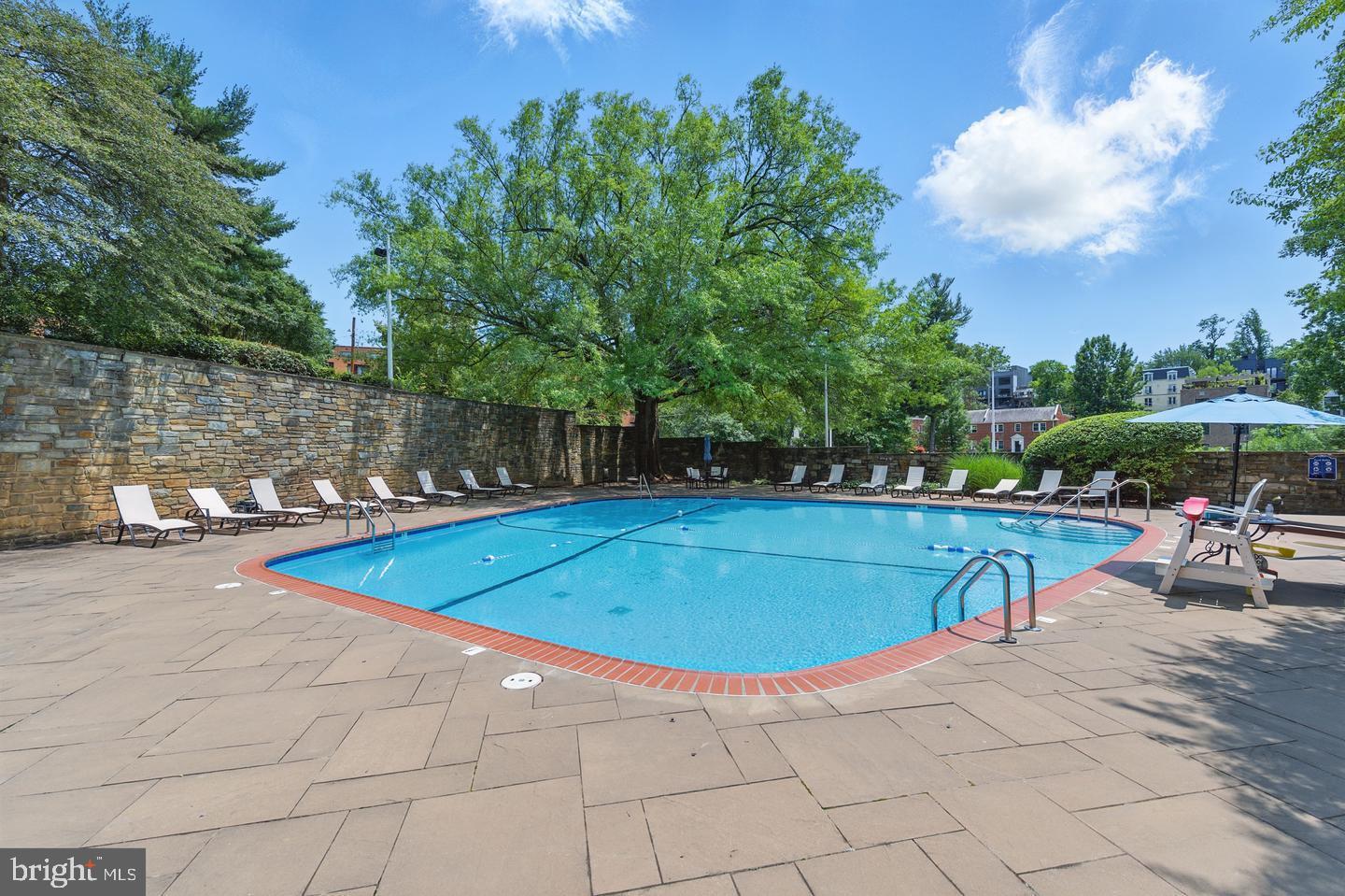 4000 Tunlaw Road Northwest, Unit 223 Washington, DC 20007 - Photo 25 of 28 a view of a swimming pool with a patio and a yard