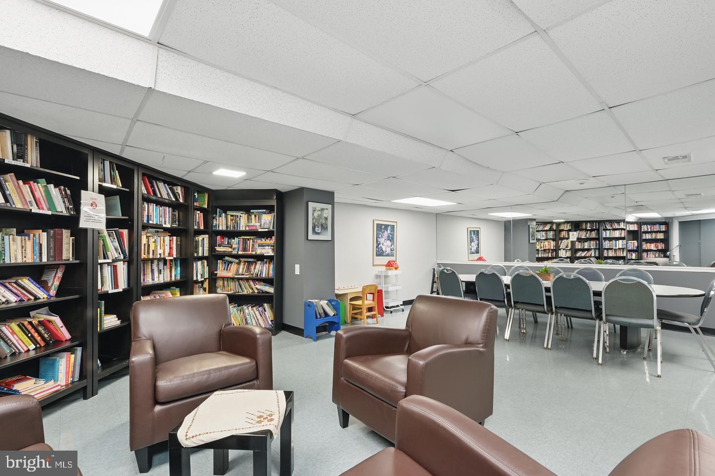 4000 Tunlaw Road Northwest, Unit 223 Washington, DC 20007 - Photo 26 of 28 a living room with furniture and a book shelf