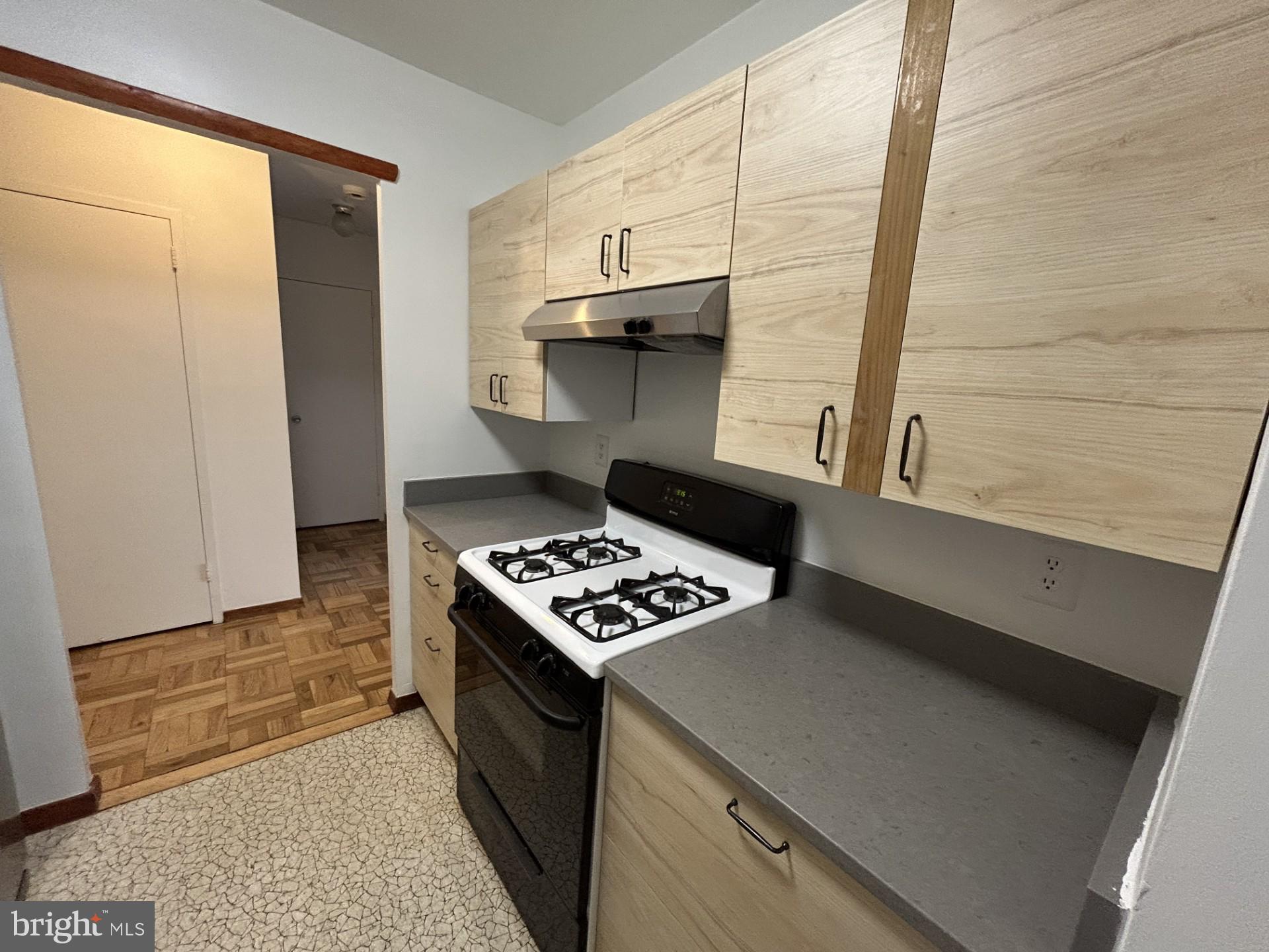 4000 Tunlaw Road Northwest, Unit 223 Washington, DC 20007 - Photo 3 of 28 a kitchen with a stove and a refrigerator