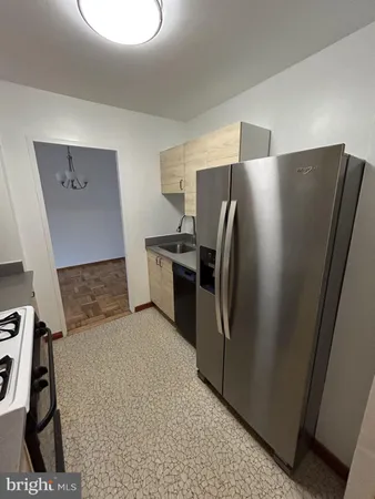 a kitchen with stainless steel appliances a refrigerator and a stove