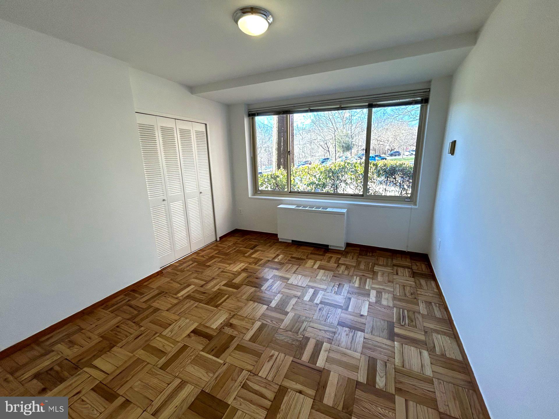 4000 Tunlaw Road Northwest, Unit 223 Washington, DC 20007 - Photo 7 of 28 a view of empty room with wooden floor and fan