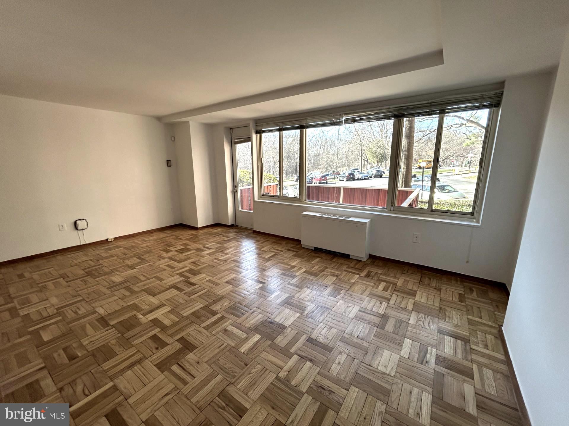 4000 Tunlaw Road Northwest, Unit 223 Washington, DC 20007 - Photo 9 of 28 a view of empty room with wooden floor and fan