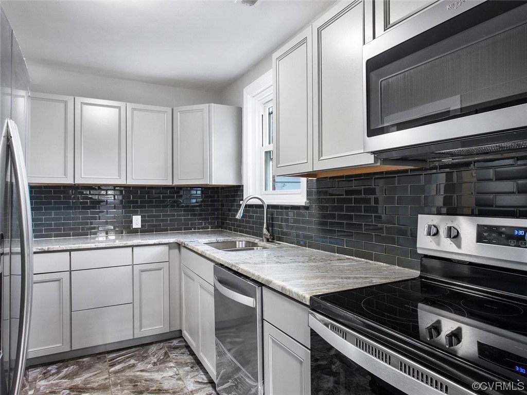 6903 Everview Road Richmond, VA 23226 - Photo 14 of 34 a kitchen with a stove microwave and sink