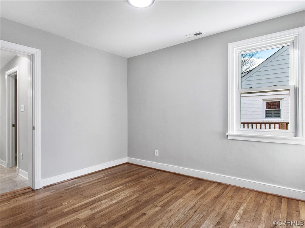 6903 Everview Road Richmond, VA 23226 - Photo 21 of 34 a view of an empty room with wooden floor and a window