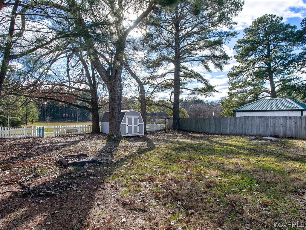 6903 Everview Road Richmond, VA 23226 - Photo 29 of 34 a view of a backyard with large trees and wooden fence