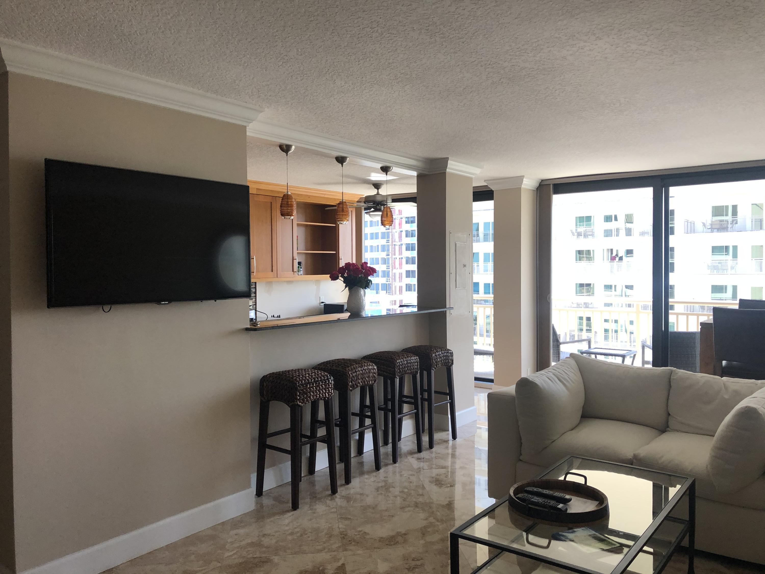 3400 North Ocean Drive, Unit 1506 Riviera Beach, FL 33404 - Photo 22 of 42 Large Screen TV in Living Room