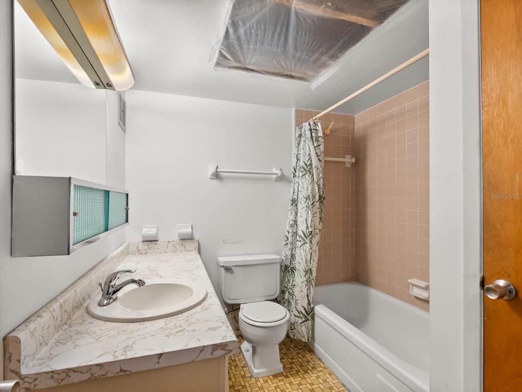 1935 South Conway Road, Unit L3 Orlando, FL 32812 - Photo 17 of 29 a bathroom with a granite countertop sink toilet and shower