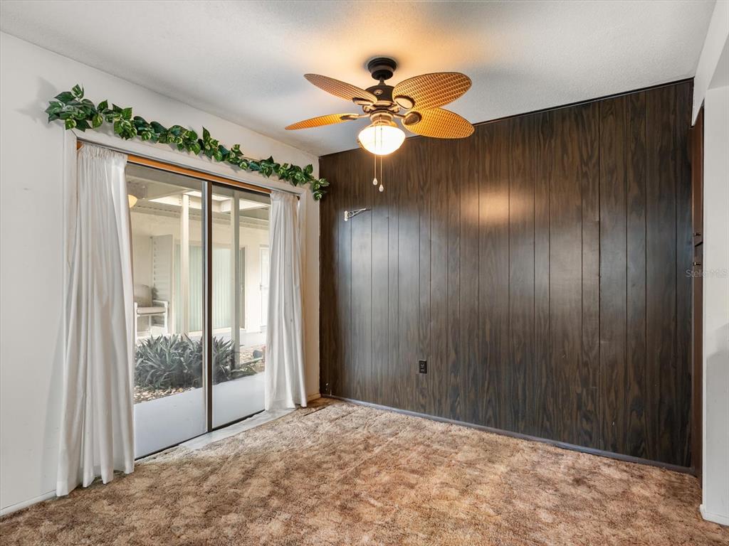 1935 South Conway Road, Unit L3 Orlando, FL 32812 - Photo 5 of 29 a view of a livingroom with a chandelier fan and a large window